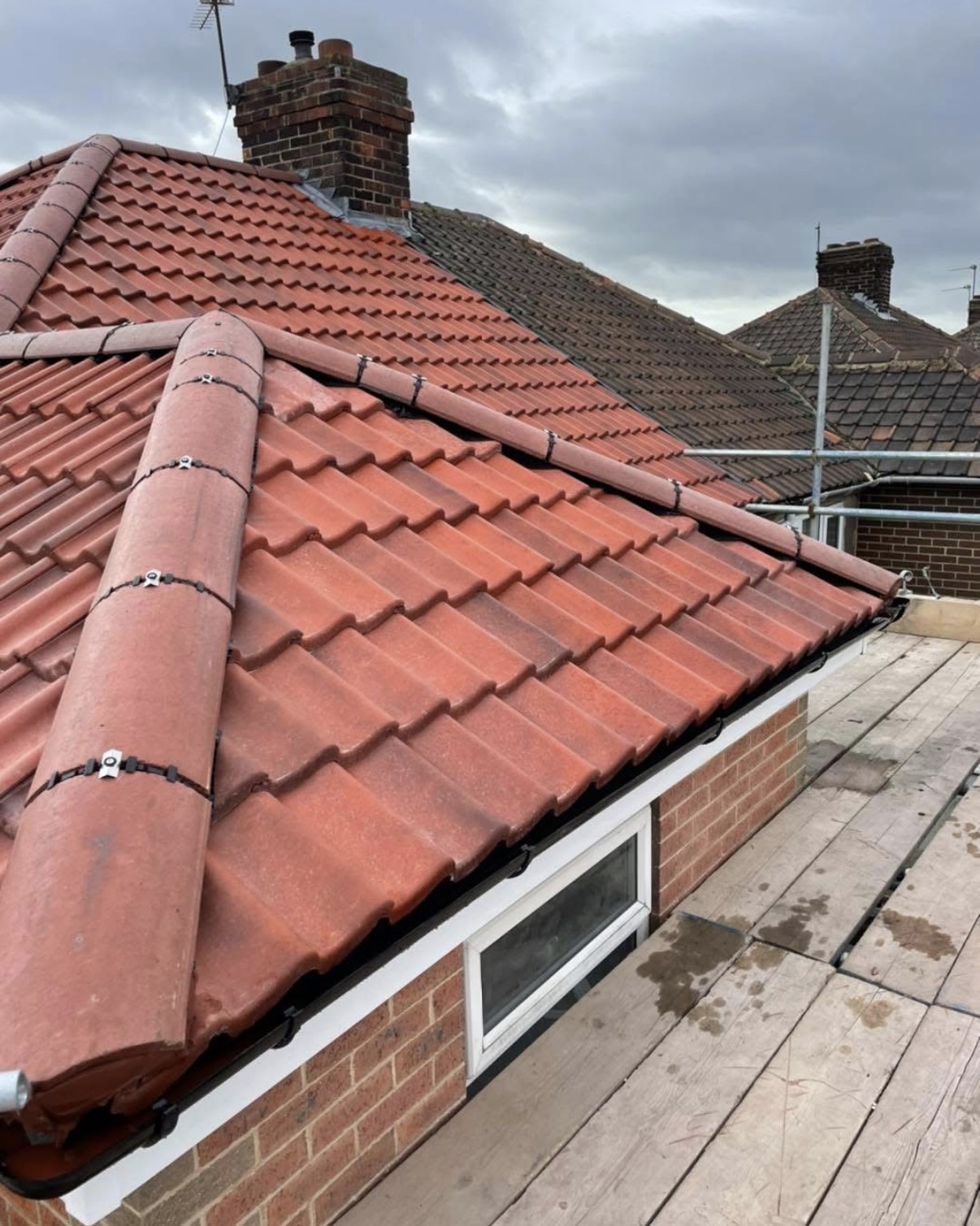 Re-roof with new tiles and leadwork